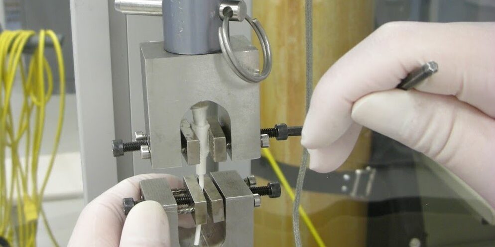 Technician using lab equipment to test medical device
